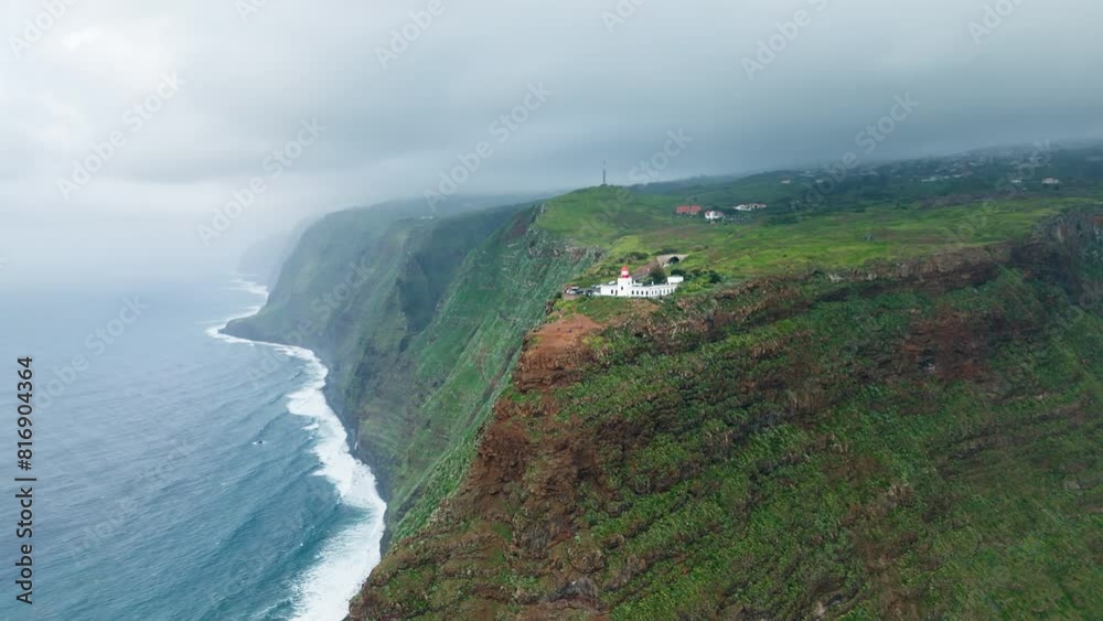 Lighthouse Of Ponta do Pargo On Rocky Cliff Escarpment In Madeira Island, Portugal. aerial shot