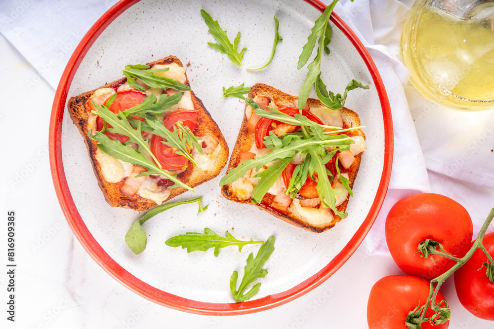Tasty crunchy toasts pizza. Fast food, modern variation of portioned quick made pizza on toast bread with tomato, bacon, mozzarella cheese and arugula, copy space
