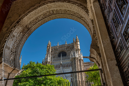 The cathedral of Seville, Spain framed by an Arabic style arch