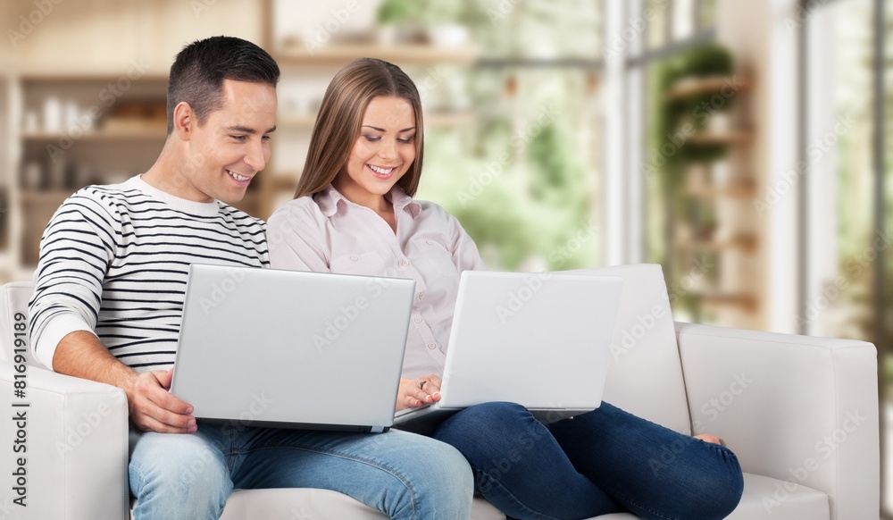 Happy young couple with laptop relaxing at home. Happy young couple with laptop relaxing at home.