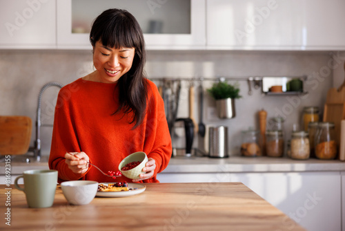 Woman adding berries to her waffles