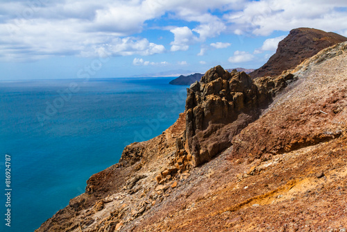 The magnificent volcanic cliffs of the Atlantic Ocean coast near the lighthouse El Faro de la Entallada, Fuerteventura, Canary Islands, Spain
