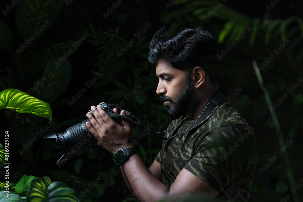 Obraz premium Photographer looking at camera screen, Wildlife photographer taking picture of nature