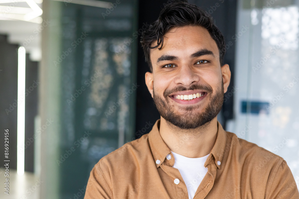 Portrait of a smiling young man in a modern office environment Portrait of a smiling young man in a modern office environment