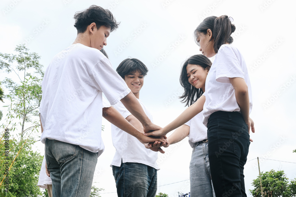 Multiracial Group of Friends with Hands in Stack Multiracial Group of Friends with Hands in Stack
