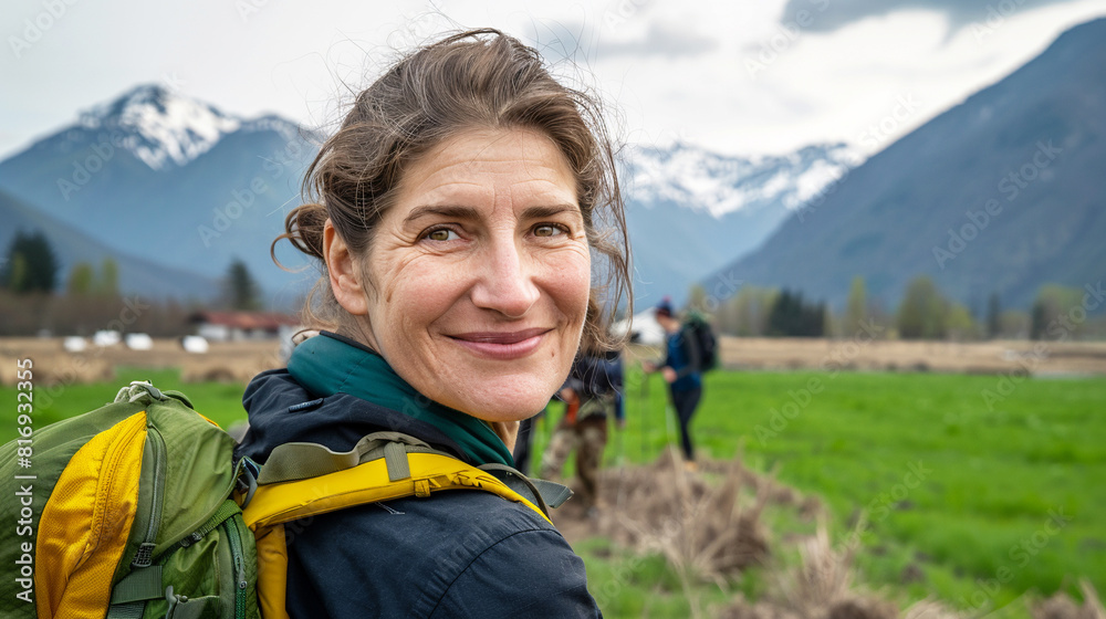 Happy smiling active senior woman with backpack trekking in the mountain. Active healthy lifestyle concept. Happy smiling active senior woman with backpack trekking in the mountain. Active healthy lifestyle concept.