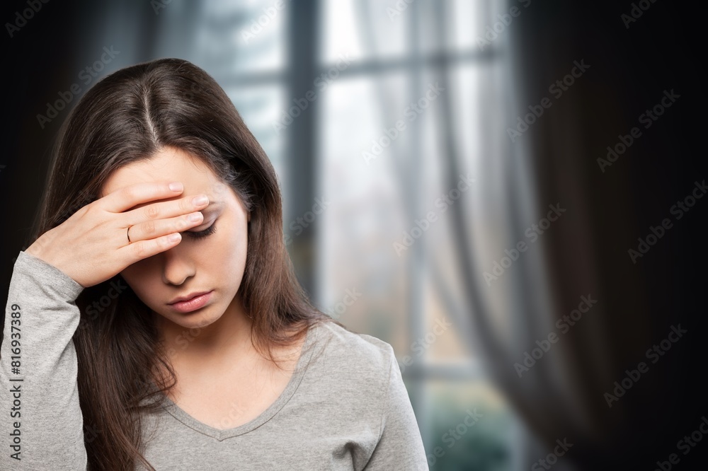 Depressed woman sitting at home, feels unhappy Depressed woman sitting at home, feels unhappy