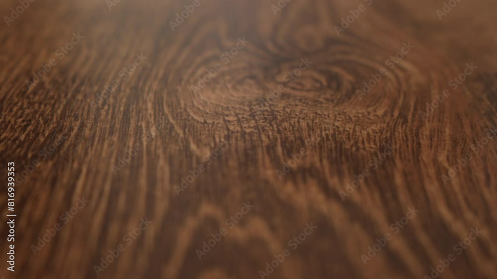 Texture of brown wooden parquet floor with natural pattern close-up. Some of the video is out of focus. Forward movement. Treated wood texture. High quality 4k footage