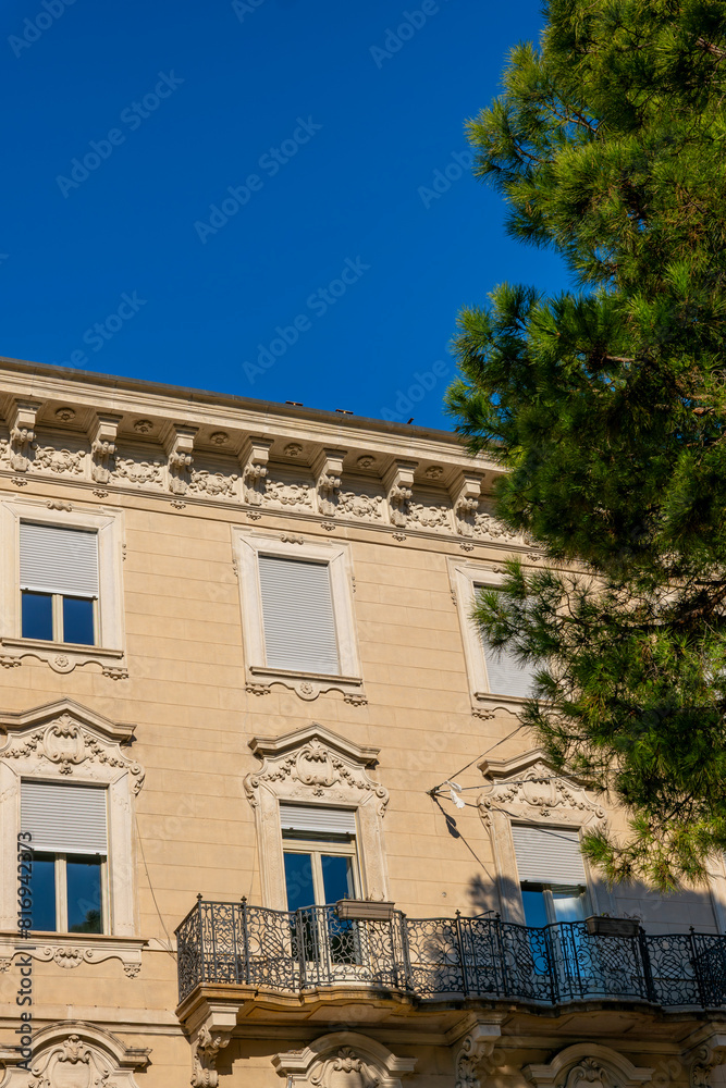 Old Beautiful Building with a Tree and Sunlight in City of Lugano, Ticino, Switzerland.