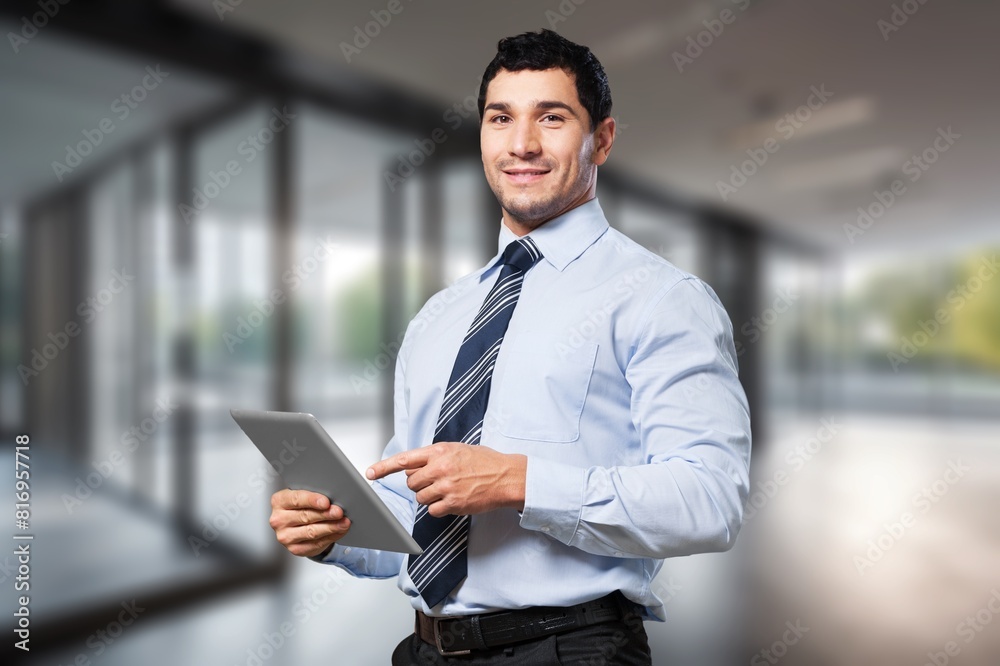 Smiling busy business manager hold tablet computer