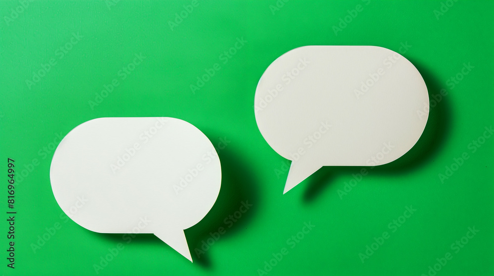 Two white speech bubbles on a bright green background, symbolizing communication and dialogue. The minimalistic design is ideal for social media or messaging concept themes. Two white speech bubbles on a bright green background, symbolizing communication and dialogue. The minimalistic design is ideal for social media or messaging concept themes.