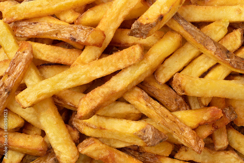 Fresh baked French peel potato fries full frame as background close up