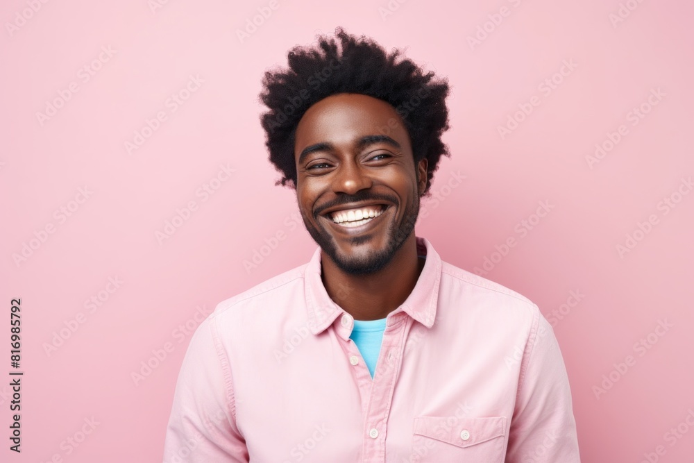 Portrait of a joyful afro-american man in his 30s smiling at the camera in pastel or soft colors background Portrait of a joyful afro-american man in his 30s smiling at the camera in pastel or soft colors background