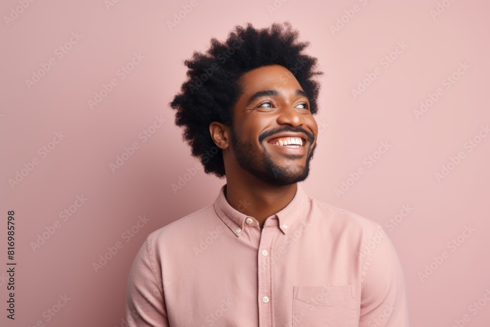 Portrait of a joyful afro-american man in his 30s smiling at the camera isolated in pastel or soft colors background Portrait of a joyful afro-american man in his 30s smiling at the camera isolated in pastel or soft colors background