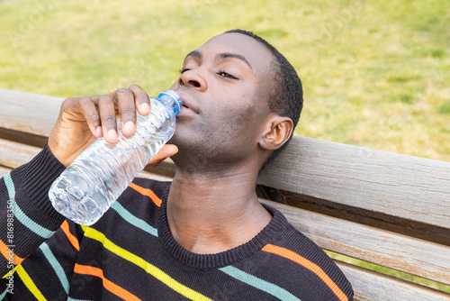 Man drinking water to manage dehydration symptoms photo