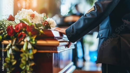 Funeral. A man in military uniform put his hand on the lid of the coffin as a sign of farewell to his brother in arms. A gesture of respect, hand on the coffin lid. photo