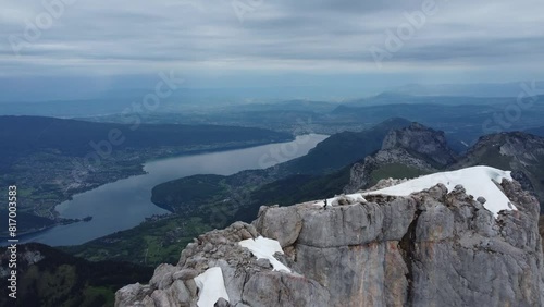 Tiny human on top of cliff in mountains