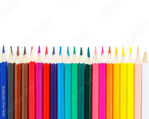 Bright colored pencils in an even row on a white background