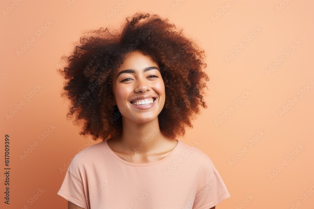 Portrait of a happy afro-american woman in her 20s smiling at the camera isolated on pastel or soft colors background Portrait of a happy afro-american woman in her 20s smiling at the camera isolated on pastel or soft colors background