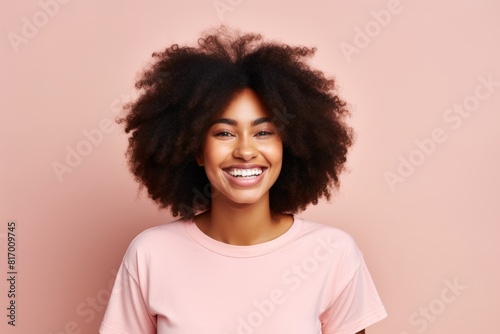 Portrait of a happy afro-american woman in her 20s smiling at the camera over pastel or soft colors background