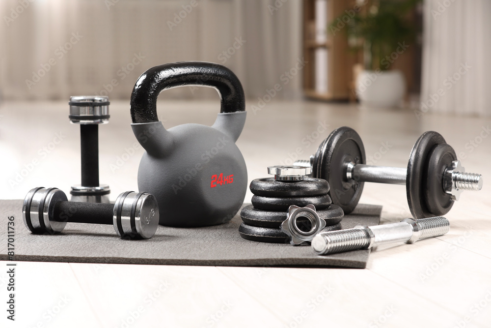 Many different sports equipment on floor indoors Many different sports equipment on floor indoors