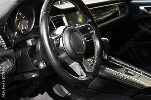 Steering wheel inside of black modern car, closeup © New Africa