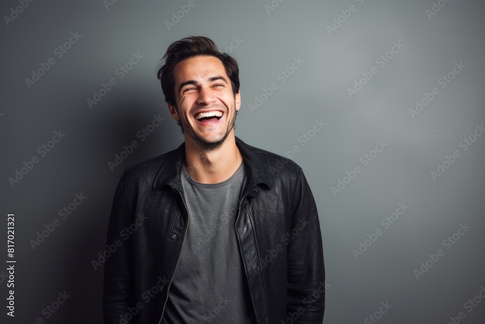 Portrait of a grinning man in his 30s laughing isolated on minimalist or empty room background Portrait of a grinning man in his 30s laughing isolated on minimalist or empty room background