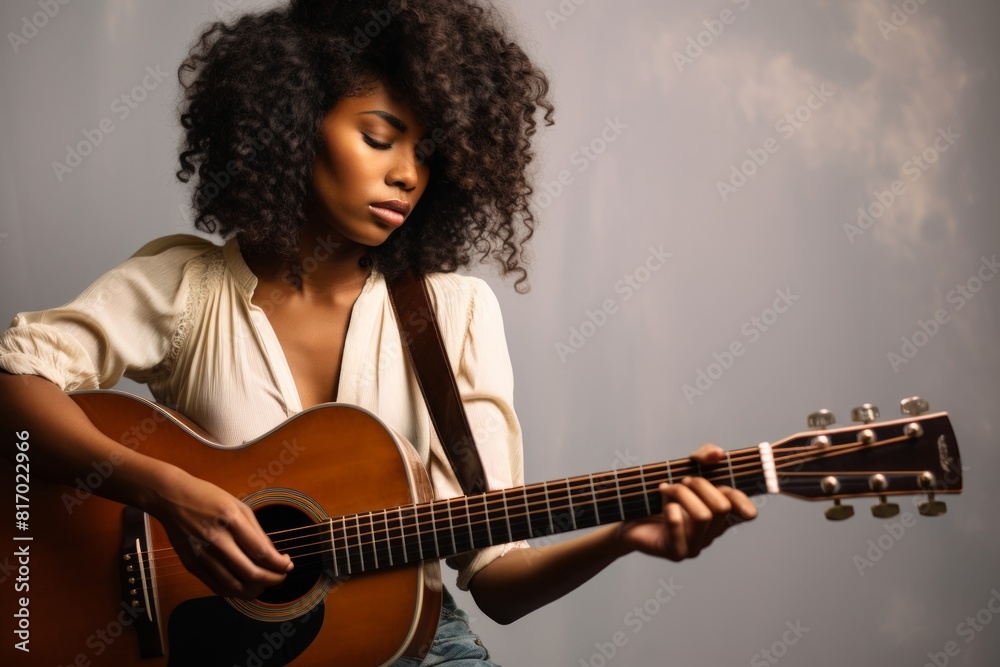 Portrait of a content afro-american man in his 30s playing the guitar isolated on minimalist or empty room background Portrait of a content afro-american man in his 30s playing the guitar isolated on minimalist or empty room background