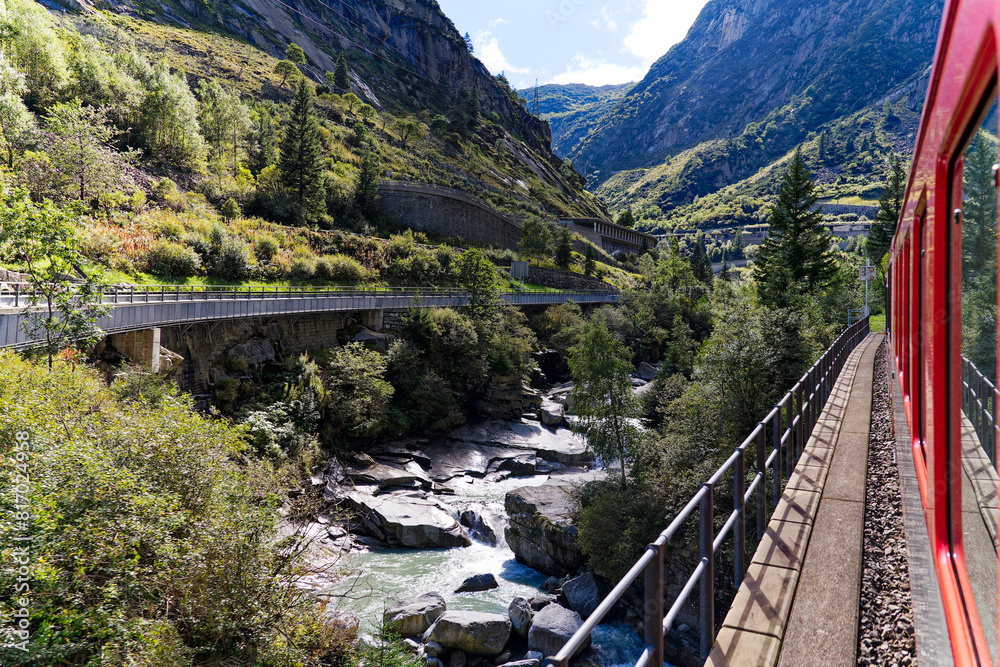 Serpentine mountain pass road at famous Schöllenen Gorge at Swiss mountain village Göschenen on a sunny late summer day. Photo taken September 19th, 2023, Göschenen, Canton Uri, Switzerland. Serpentine mountain pass road at famous Schöllenen Gorge at Swiss mountain village Göschenen on a sunny late summer day. Photo taken September 19th, 2023, Göschenen, Canton Uri, Switzerland.