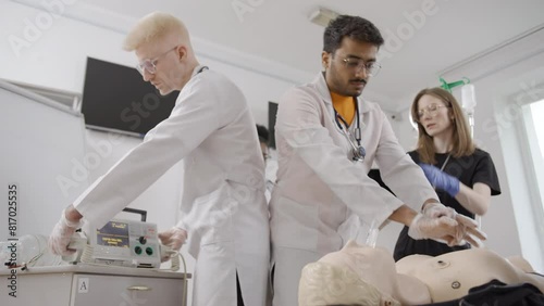 CPR. International medical students resuscitating a dummy photo