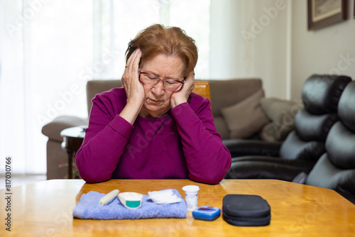 Elderly woman managing hypoglycemia symptoms at home photo