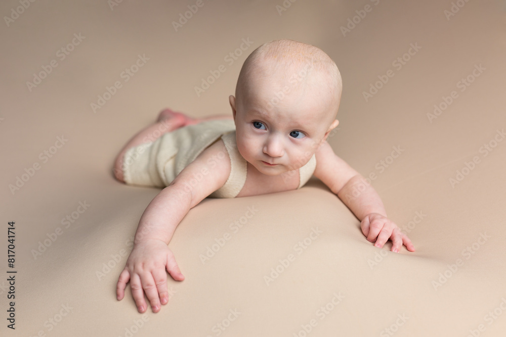 a small child lies on a light background. newborn boy. baby's first photo shoot