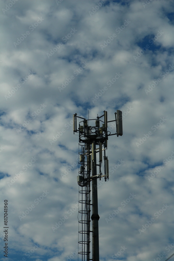 A tall tower with a satellite dish A tall tower with a satellite dish