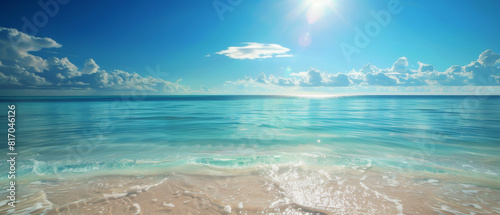 A beautiful blue ocean with a bright sun shining on the water
