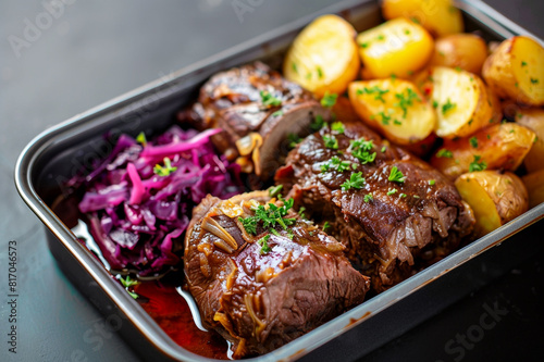 Delicious beef roulade with potatoes and red cabbage in lunch box container