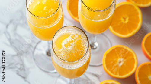 Three glasses of orange juice with a straw in the middle photo