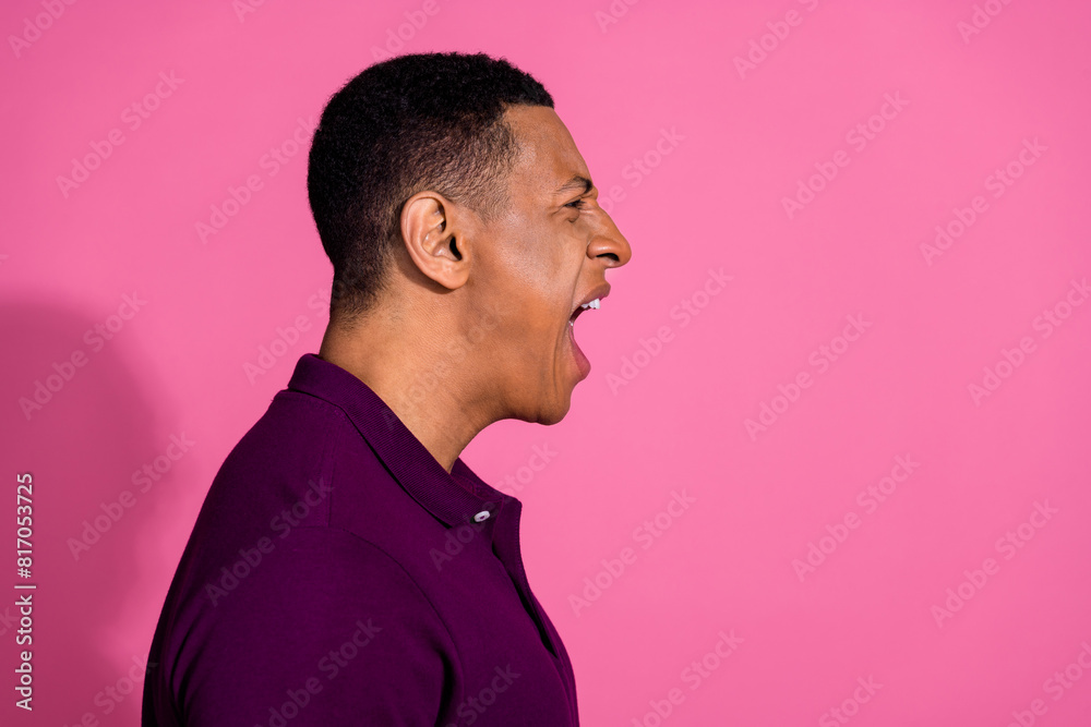 Photo portrait of nice young male profile angry scream dressed stylish violet garment isolated on pink color background Photo portrait of nice young male profile angry scream dressed stylish violet garment isolated on pink color background