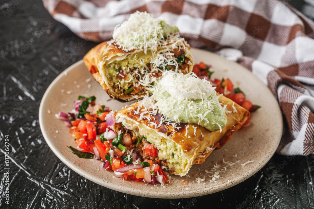 set of delicious fresh colorful deep-fried chimichanga on a dark background set of delicious fresh colorful deep-fried chimichanga on a dark background