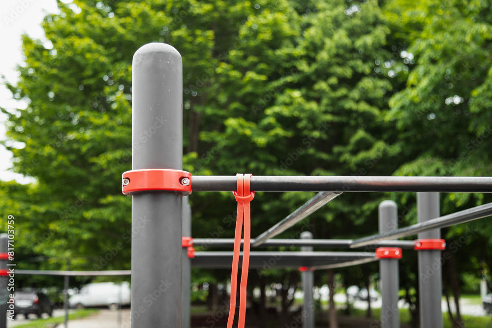 Elastic rubber band for exercise tied on a horizontal bar . Outdoor gym concept Elastic rubber band for exercise tied on a horizontal bar . Outdoor gym concept