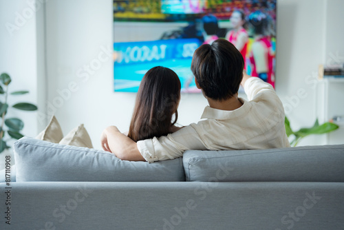 Cozy couple enjoying movie night at home
