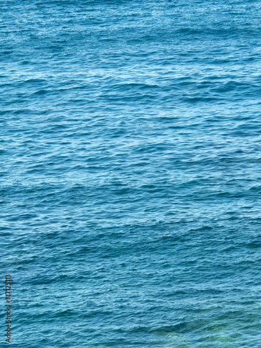 Vertical dark blue sea ripples background © photohampster
