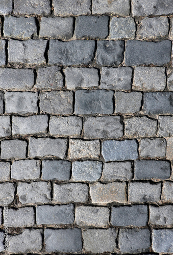 Background from rough grey cobblestone pavement