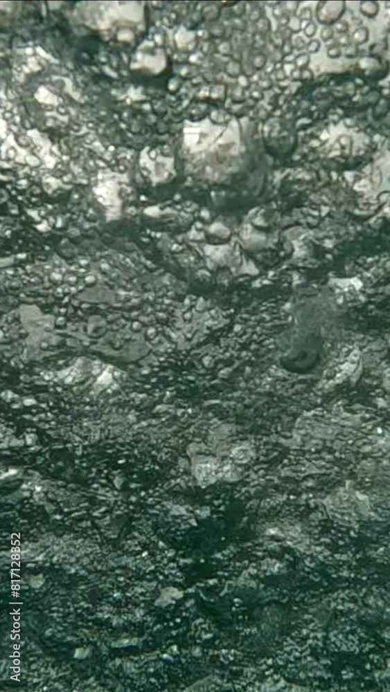 Vertical video, Seething surface of water during tropical storm, large drops of heavy rain falling on water, Underwater view on rainstorm below water surface of the Ocean, Slow motion Vertical video, Seething surface of water during tropical storm, large drops of heavy rain falling on water, Underwater view on rainstorm below water surface of the Ocean, Slow motion