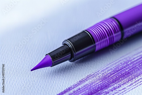 Purple pen with black tip on white paper with purple ink