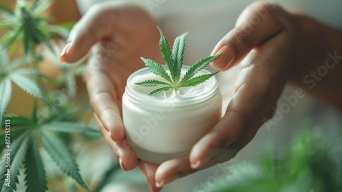 Hand Holding Cannabis-Infused Cream with Green Leaves
