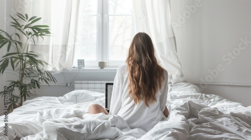 Photo of Woman working office work remotely on bed at home