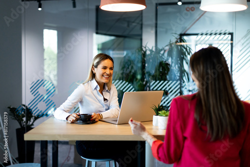 Two women collaborating in ...