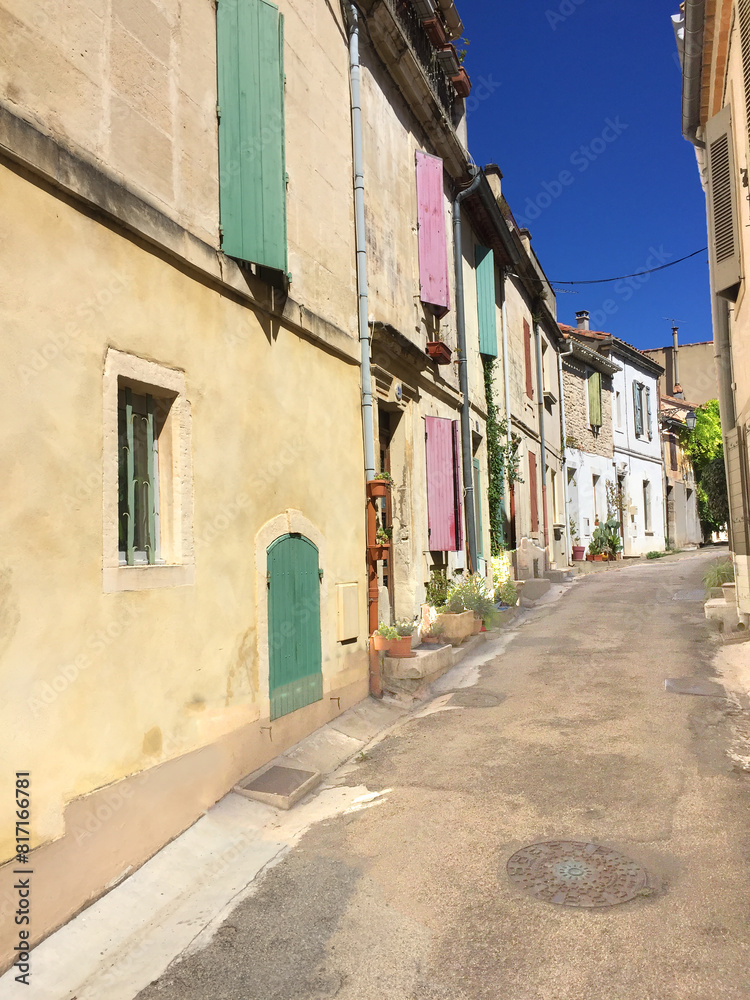 narrow small street with old houses in typical architecture style in Arles, France