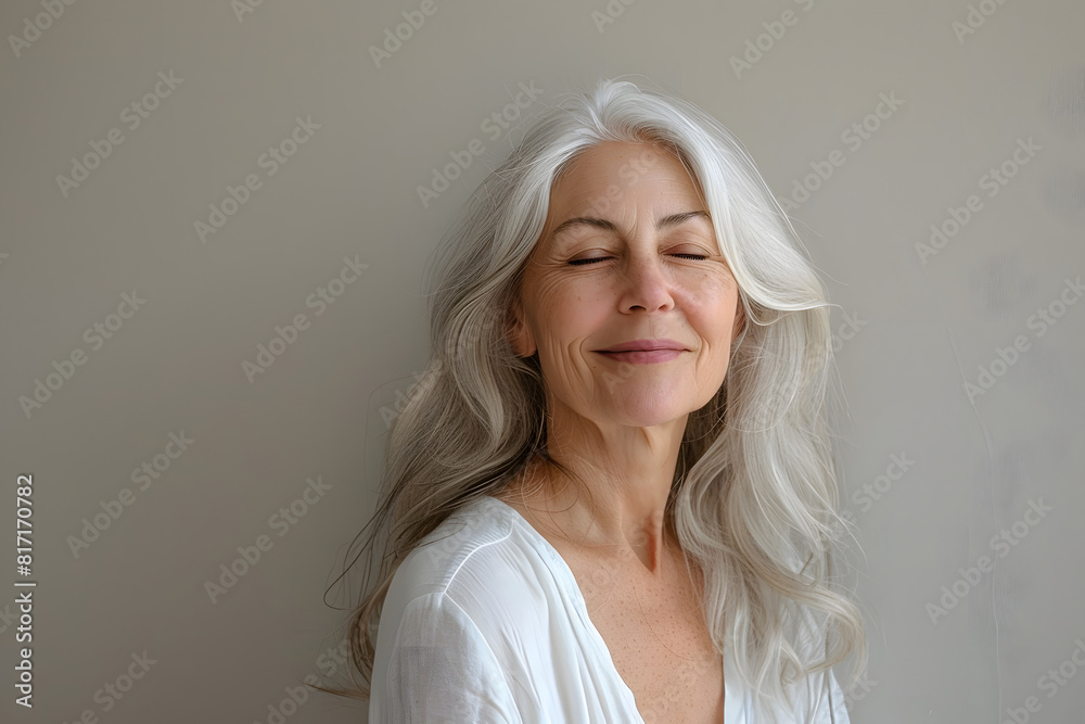 Beautiful middle aged woman smiling without makeup with her eyes closed, showing her wrinkles and skin textures Beautiful middle aged woman smiling without makeup with her eyes closed, showing her wrinkles and skin textures