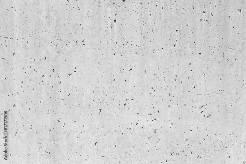 New exposed concrete wall displaying distinct perforations resulting from the gradual evaporation of the mixing water during the curing process